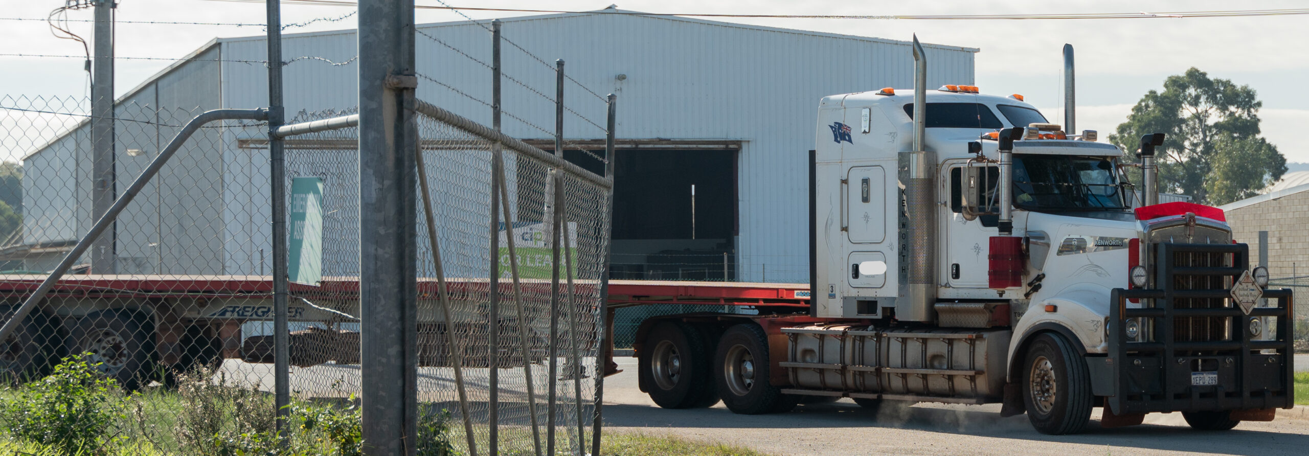 A haulage truck about to get towed by a heavy tow truck.