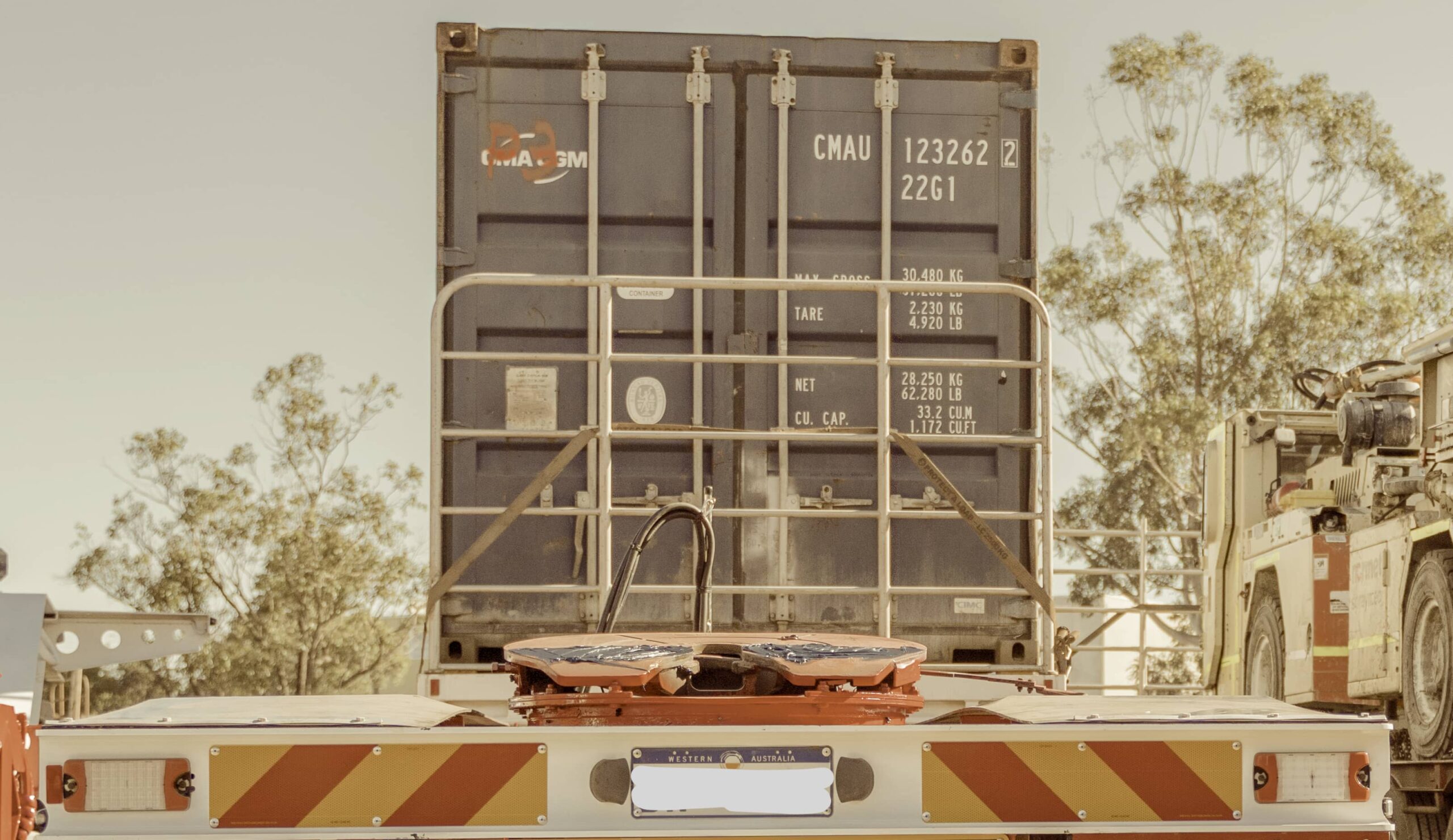 A shipping container on a large truck ready to be transported.