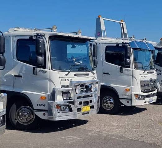 Trucks getting ready to tow busses in Sydney.