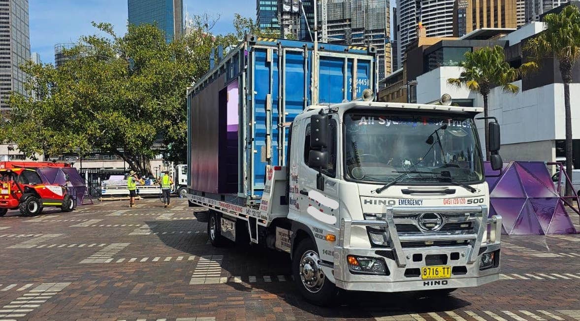 Container on a tilt tray tow truck in Sydney. 